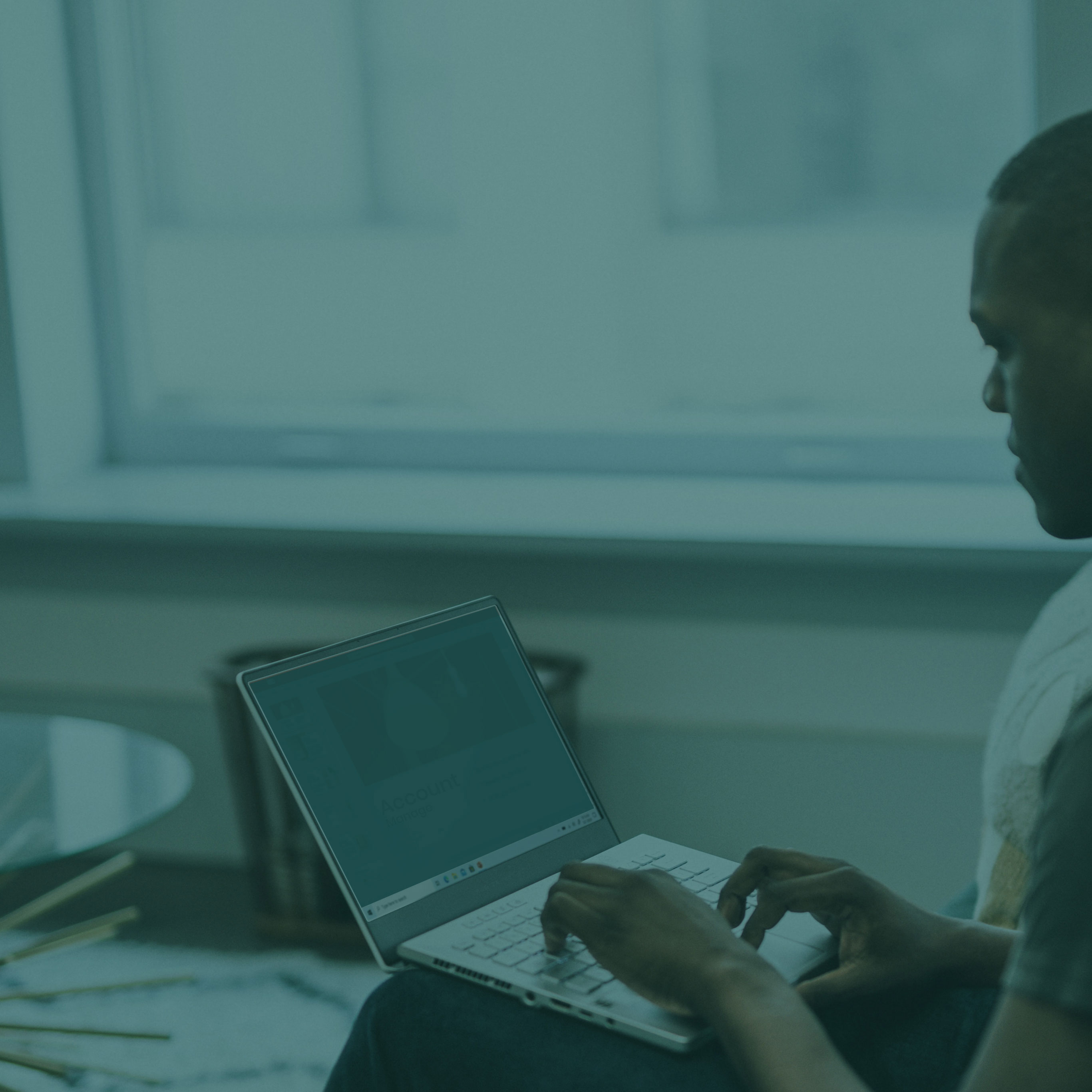 Man sitting on a laptop typing